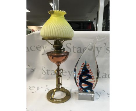 An art glass decorative piece/ paperweight and a copper/brass oil lamp with yellow glass shade