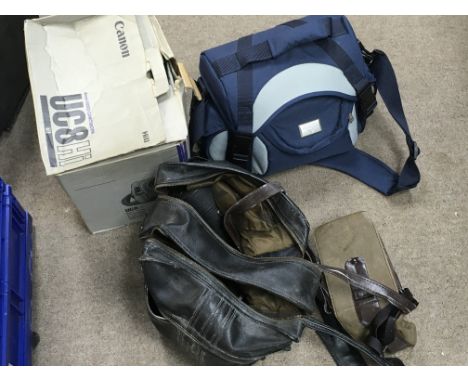 A collection of vintage camera equipment including a Canon 8mm video camcorder, Samsung 8mm
