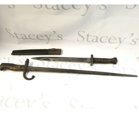 Two bayonets including an English bayonet marked EFD, scabbard damaged. 45cm long and a French bayonet, 61cm long.