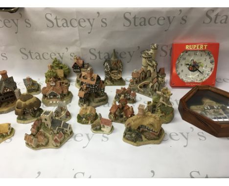 A collection of David Winter cottages and a Wedgewood Rupert clock. No reserve