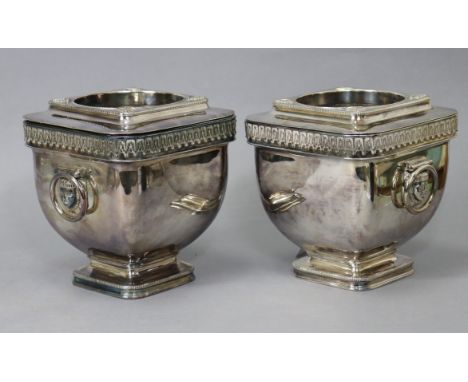 A pair of silver-plated wine coolers of curved square form, with Pharoah mask &amp; ring side handles, &amp; removable liners