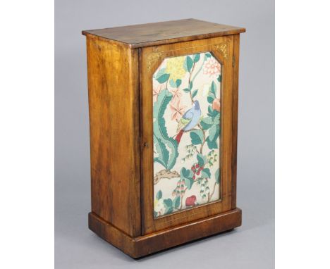 A Victorian inlaid walnut sheet music cabinet fitted two shelves enclosed by a glazed door, on plinth base with ceramic casto