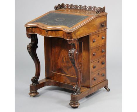 A Victorian walnut davenport with a pierced tray-top gallery above a fitted interior enclosed by a hinged sloping lid with gi