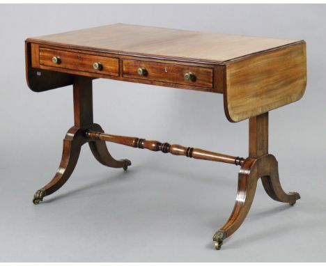 A regency mahogany sofa table, with ebonised inlay &amp; rosewood crossbanding, fitted two frieze drawers to one side, on fou