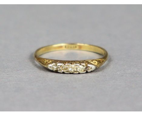 An 18ct gold ring set five small rose diamonds, size Q/R, 2.2g.