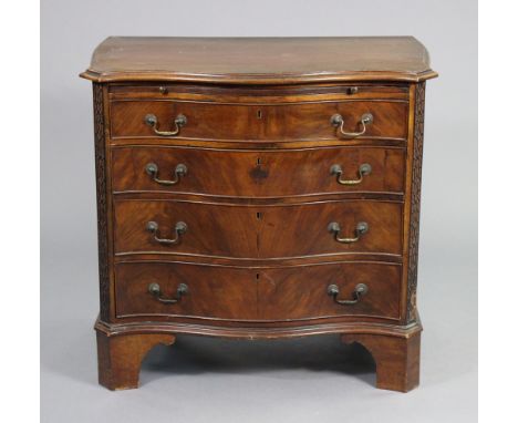 A GEORGE III MAHOGANY SERPENTINE-FRONT CHEST, fitted brushing slide above four long graduated drawers with original brass swa