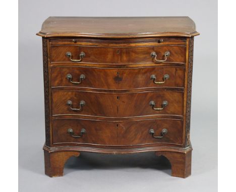 A GEORGE III MAHOGANY SERPENTINE-FRONT CHEST, fitted brushing slide above four long graduated drawers with original brass swa