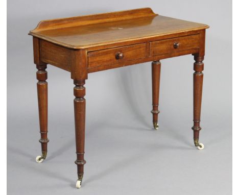 A Victorian mahogany side table by Edwards &amp; Roberts, with raised back to the rounded rectangular top, fitted two frieze 