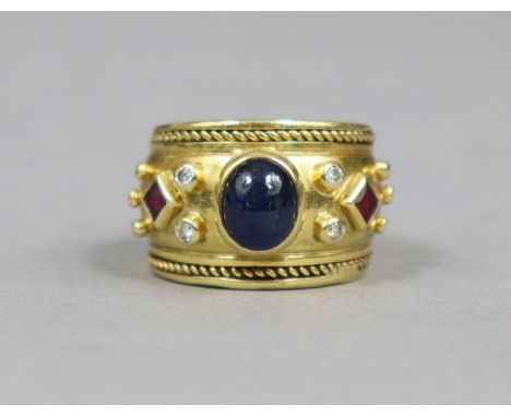 A heavy yellow metal ring set oval cabochon sapphire flanked by pairs of small diamonds &amp; a square-cut ruby either side, 