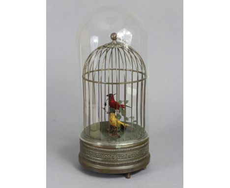 A 20th century birdcage automaton featuring two songbirds amongst foliage, each singing in turn, with later glass dust shade,