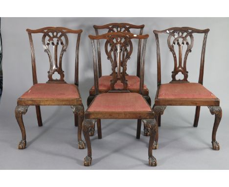 A set of four Chippendale-style mahogany dining chairs with pierced splat backs &amp; padded drop-in seats on carved cabriole