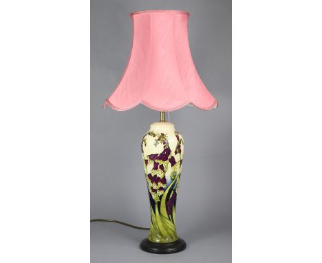 A Moorcroft pottery vase mounted as a table lamp, with ‘foxgloves’ design on a cream ground, slender baluster form, with shad