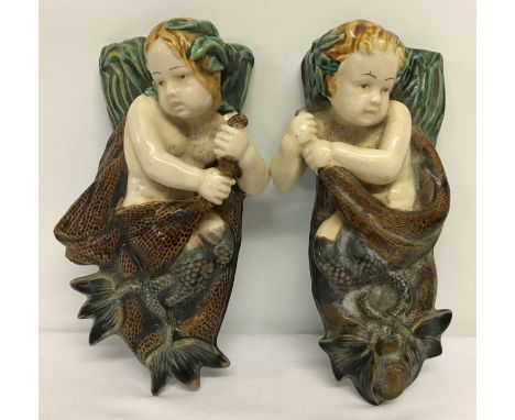A pair of mermaid and merboy majolica glazed ceramic wall pockets.   Approx. 24cm tall.