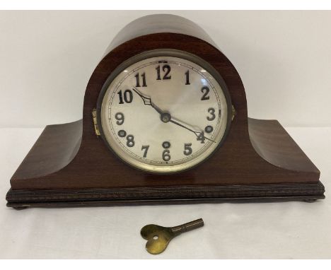 A vintage dark wood cased napoleon's hat style mantle clock with Westminster &amp; Whittington chime.  Complete with key and 