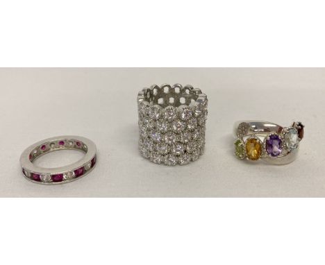 3 modern design silver stone set dress rings.  A large honeycomb design band ring set with clear cubic zirconia stones, a ful