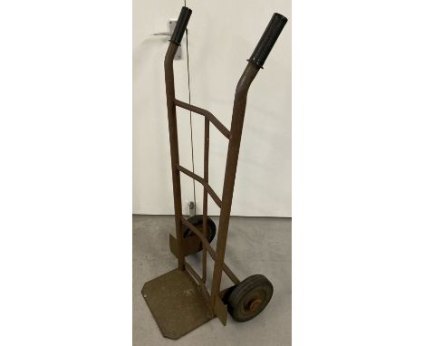 A vintage metal sack barrow with rubber tyres and grip handles.  Approx. 100cm tall.