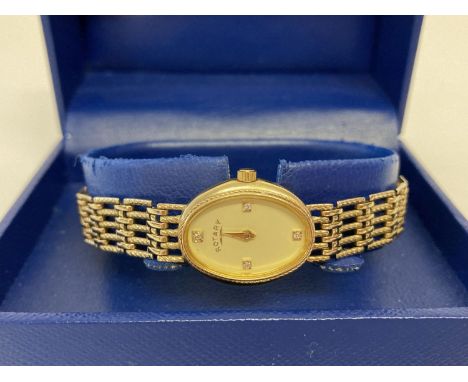 A boxed ladies 9ct gold wristwatch by Rotary. Face set with 4 small diamonds.  Complete with instruction book and diamond cer