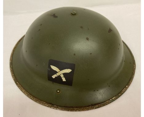 A WWII style British helmet issued to a Gurkha unit.  Has makers marks for "Fisher &amp; Ludlow" and showing 1939 date stamp.