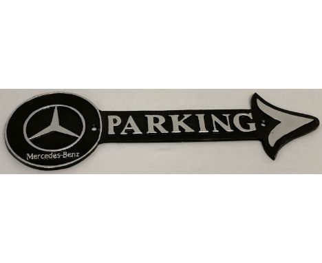 A painted cast iron wall hanging Mercedes parking arrow, in black and silver.   Approx. 40.5cm long.