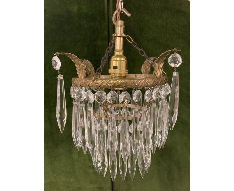 A vintage French style 2 tier brass and crystal chandelier with decorative brass leaf overhangs.  Fully restored and rewired.