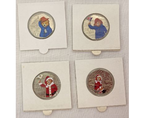 A collection of 4 Paddington Bear 50p coins with sticker decals.  Paddington At The Station and Paddington At The Palace with