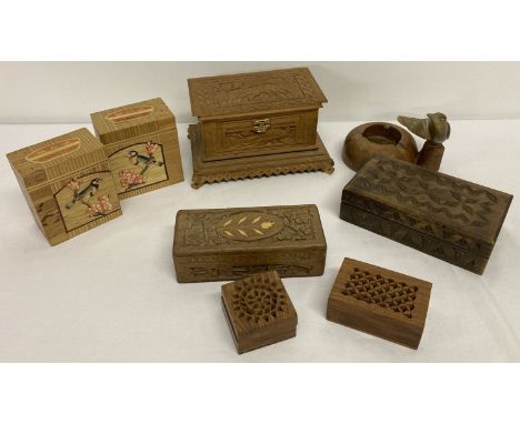 A collection of vintage small wooden boxes together with a wooden ashtray with bird detail.  