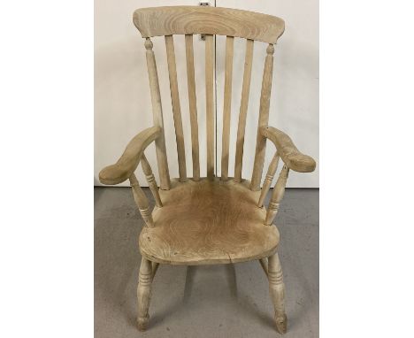 A vintage stripped pitch pine slat back arm chair.   Approx. 104cm tall.