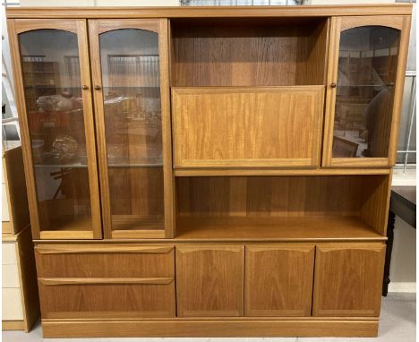 A large retro teak wood wall unit by McIntosh.  2 large drawers, double cupboard with interior shelf and single cupboard to b