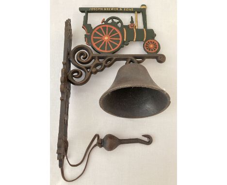 A painted cast metal wall hanging garden bell with Joseph Brewer &amp; sons Traction engine detail.   Approx. 37cm tall.