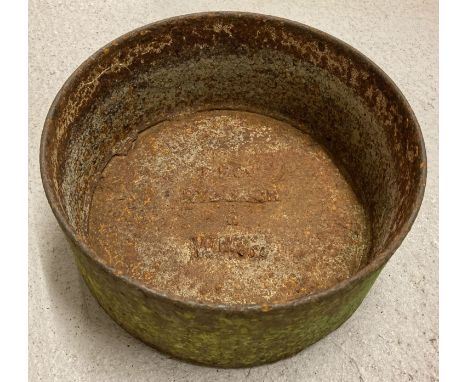 A vintage circular iron Quench trough marked F.F.C. Ruburgh Wm. H.   Approx. 16cm tall x 34cm diameter.