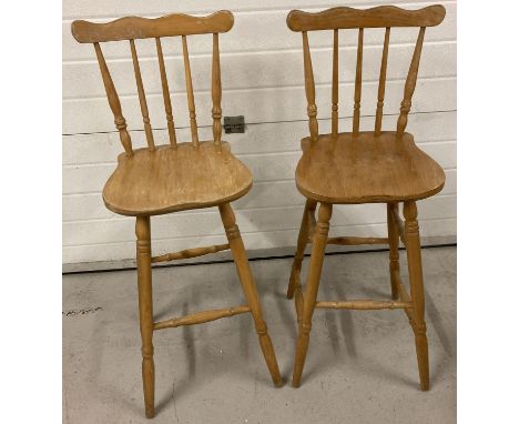 A pair of light wood bar/kitchen stools with spindle backs and turned legs.   Total height approx. 104cm.