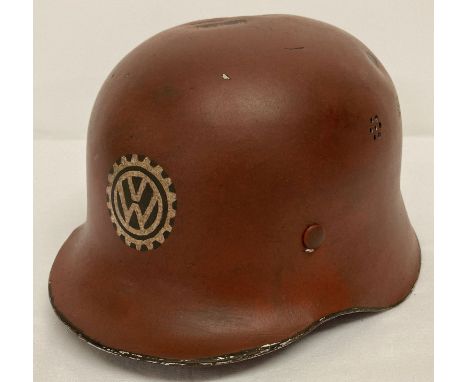 A German WWII style lightweight fire helmet, red with VW factory hand painted decal.  Complete with leather liner to interior