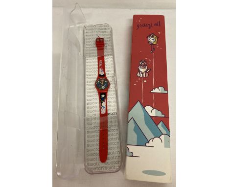 A boxed Swatch watch. Red plastic strap with floral detail to both face and strap. In working order.  Complete with instructi