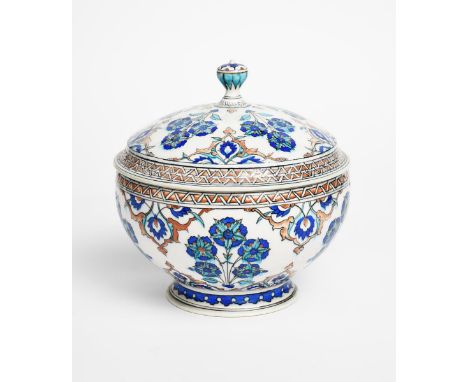 A Theodore Deck Pottery Iznik bowl and cover, painted with stylised Persian flowers and foliage in blue, turquoise, red and b