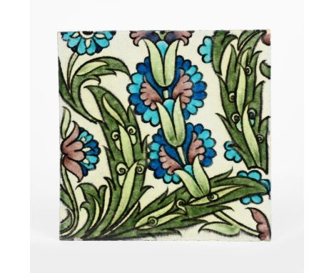A William De Morgan Late Fulham Period Persian tile, painted with flowers and foliage in blue, pink and green on a cream grou