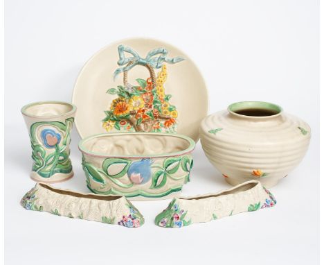 A Clarice Cliff wall charger, modelled in low relief with a basket of flowers, glazed in colours on a mushroom ground, a Clar