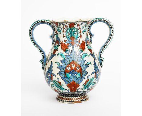 A Cantagalli Pottery Iznik twin-handled vase, swollen, footed form, painted with Persian floral panels in blue, turquoise and