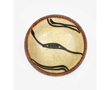 ‡ Ray Finch MBE (1914-2012) a Winchcombe Pottery slip decorated plate, with pie crust rim, painted with simple motif in black