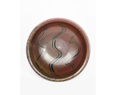 ‡ Ray Finch (1914-2012) a large Winchcombe Pottery stoneware platter, circular form, covered in a brown glaze, with pulled oc