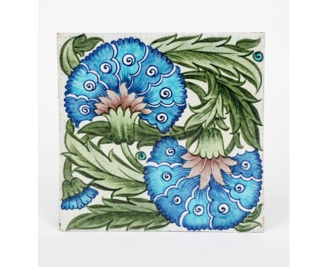A large William De Morgan Sand's End Pottery Double Carnation tile, painted in shades of blue, green and aubergine on a white