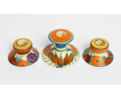 'Lily' a Clarice Cliff Fantasque Bizarre candlestick, shape no. 310, retailed by Lawley's, painted in colours, and a pair of 