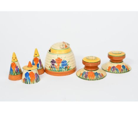 'Crocus' a pair of Clarice Cliff Bizarre candlesticks, model no.331, painted in colours, a Clarice Cliff 'Crocus' conical cru