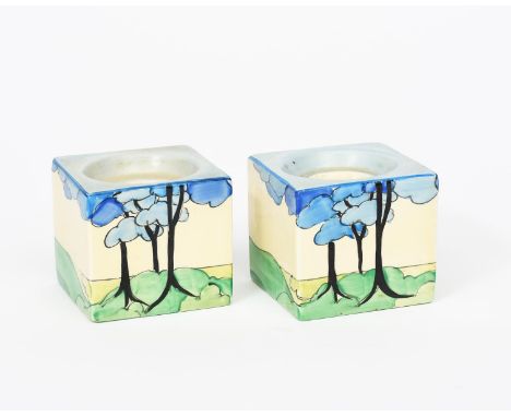 'Blue Firs' a pair of Clarice Cliff Bizarre Cube candlesticks, shape no.658, painted in colours printed factory marks, 6cm. s