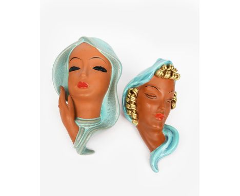 A Goldscheider Pottery wall mask, model no.7813, modelled as a woman with turquoise flowing long hair, and another wall mask 