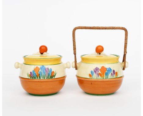 'Crocus' a Clarice Cliff biscuit barrel and cover, shape no.335, painted in colours, with wicker handle, and another Clarice 