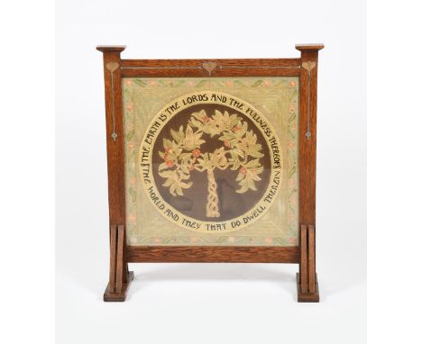 An Arts and Crafts oak firescreen with embroidered panel, the frame inlaid with pewter Art Nouveau panels, the rectangular em