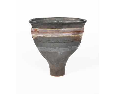 ‡ Robin Welch (1936-2019) a flaring stoneware vase, with everted rim, matt black with translucent lavender band, impressed RW