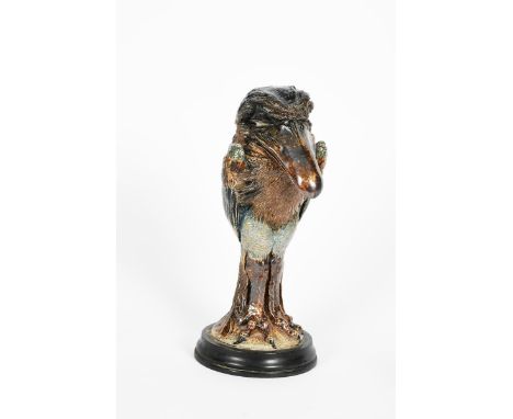 A Martin Brothers stoneware bird jar and cover by Robert  Wallace Martin, modelled standing on long slender legs, long tail f