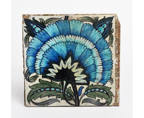 A William De Morgan Sands End Pottery large tile, painted with a fan flower in blue, green and black on a white ground, impre