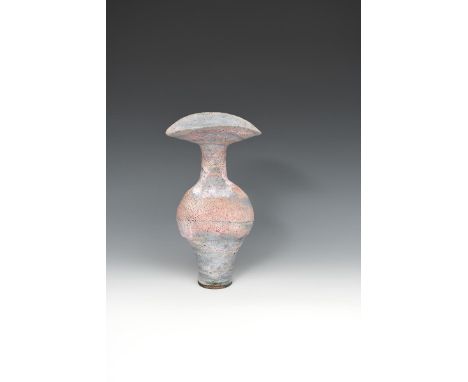 ‡ Dame Lucie Rie (1902-1995) a tall stoneware bottle vase with flaring rim, the narrow foot supporting swollen body, pinched 